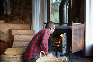 Man checking wood burning stove